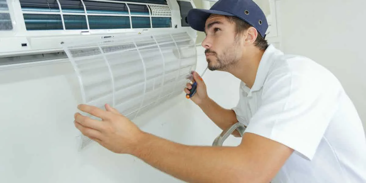 HVAC technician inspecting an air conditioning system