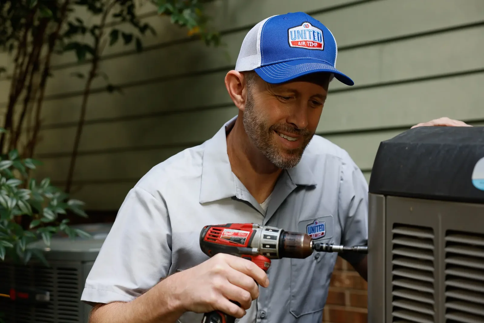 HVAC service professional working on outdoor equipment